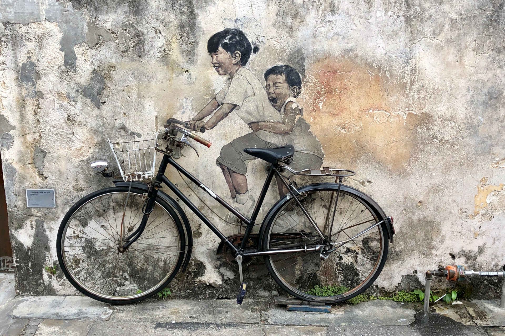 Little children on a bicycle, street art Penang